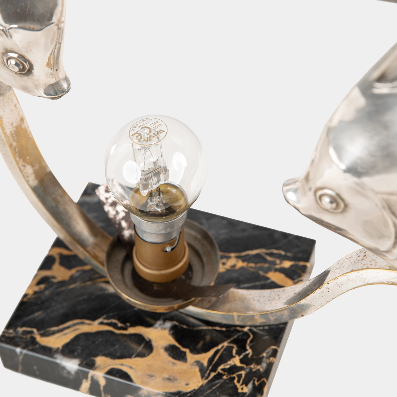 Original French Art Deco table lamp ca. 1930, signed by M. Font on both silvered metal fish figures, with sculptural design, frosted glass globe, and black Portoro marble base with natural golden veining. Measures 12.2 in high, 13.4 in wide, and 4.3 in deep.