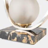Original French Art Deco table lamp ca. 1930, signed by M. Font on both silvered metal fish figures, with sculptural design, frosted glass globe, and black Portoro marble base with natural golden veining. Measures 12.2 in high, 13.4 in wide, and 4.3 in deep.