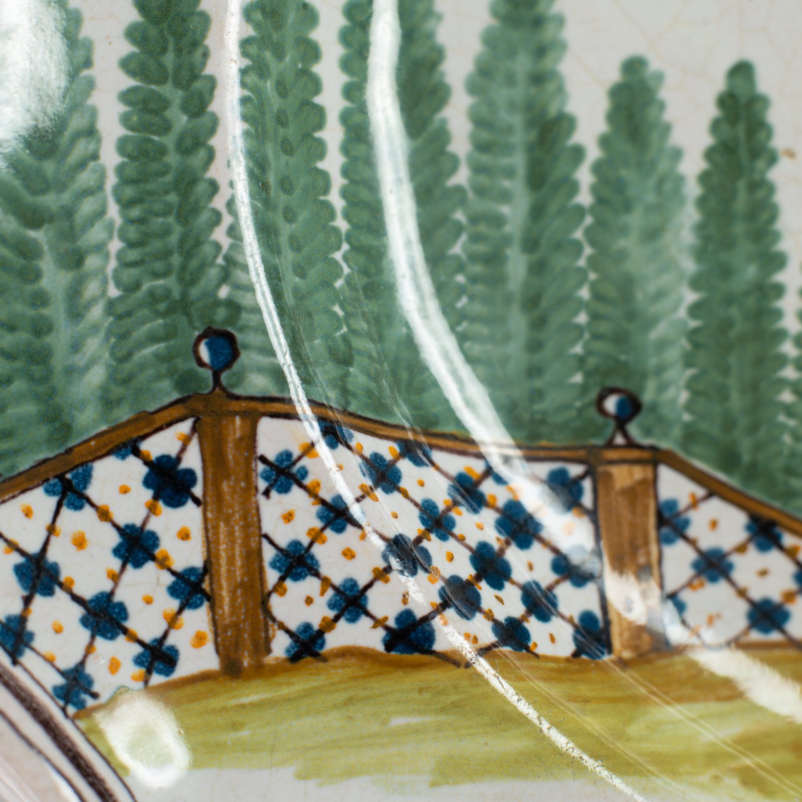Oval faience plate, France, ca. 1760–1790, attributed to Rouen; tin-glazed earthenware with hand-painted chinoiserie scene in enamel pigments (cobalt, manganese, copper, antimony); figures in stylized garden within manganese-lined scalloped rim; ivory glaze with fine, stable craquelure