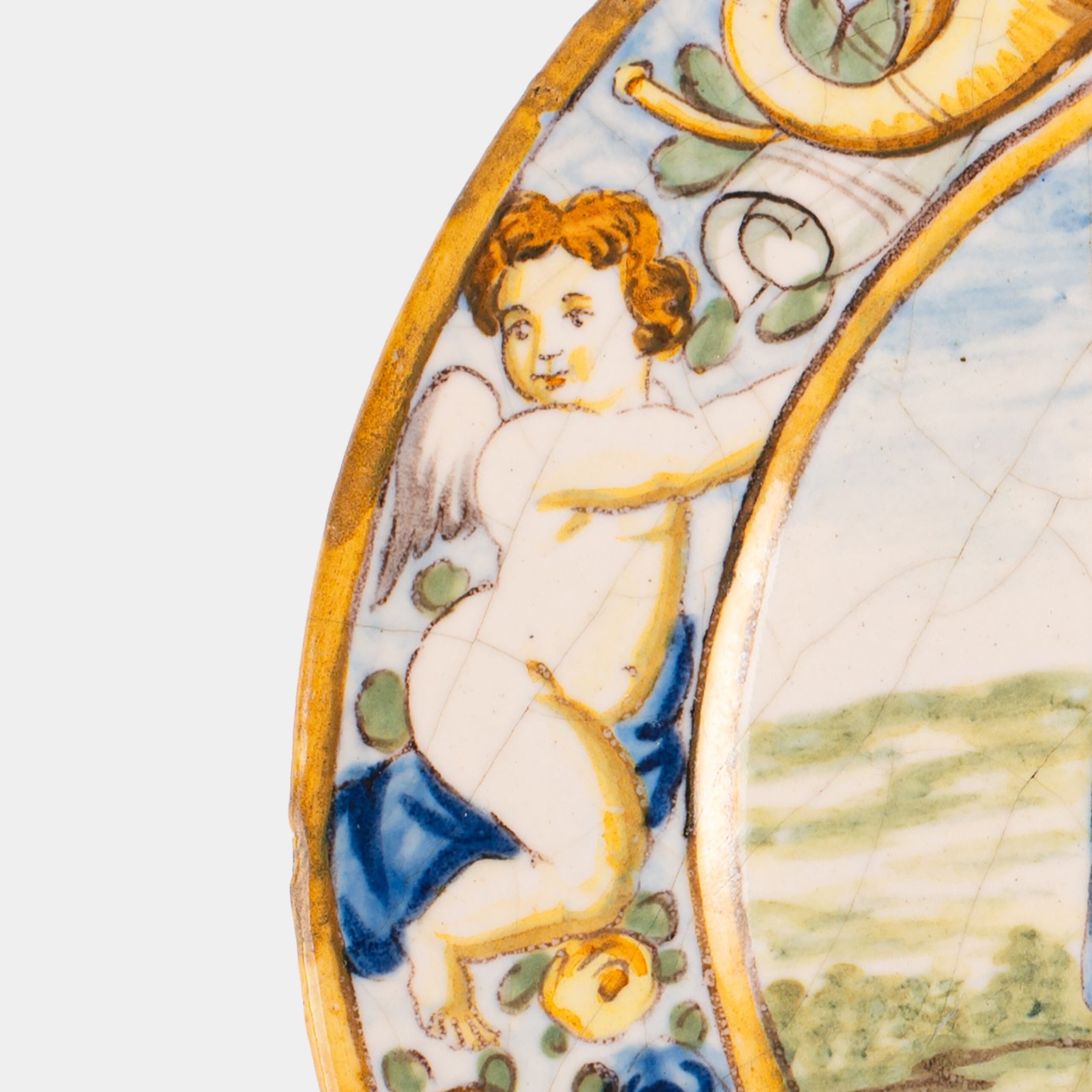 Hand-painted Italian maiolica plate, Deruta or Urbino, late 17th to early 18th century. Depicts Mercury with winged sandals beside a female figure, likely an allegory of Peace, Concord, or Wisdom. Rich Baroque border with cherubs, musical instruments, and cartouches. Tin-glazed earthenware with visible craquelure and minor rim losses.