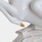 Glazed white porcelain sculpture signed by Max Hermann Fritz and produced by Hutschenreuther Selb between 1925 and 1935. Depicts a nude female figure riding a leaping ibex, with hand-applied gilding on the horns, eyes, hooves, and base. German Art Deco style.
