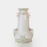 Art Nouveau porcelain vase by Karl Ens, circa 1900, featuring a sculptural composition in high relief with a maiden and cherub, hand-painted with floral details and highlighted with gilding. Marked “KVE” on the base.