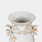 Art Nouveau porcelain vase by Karl Ens, circa 1900, featuring a sculptural composition in high relief with a maiden and cherub, hand-painted with floral details and highlighted with gilding. Marked “KVE” on the base.