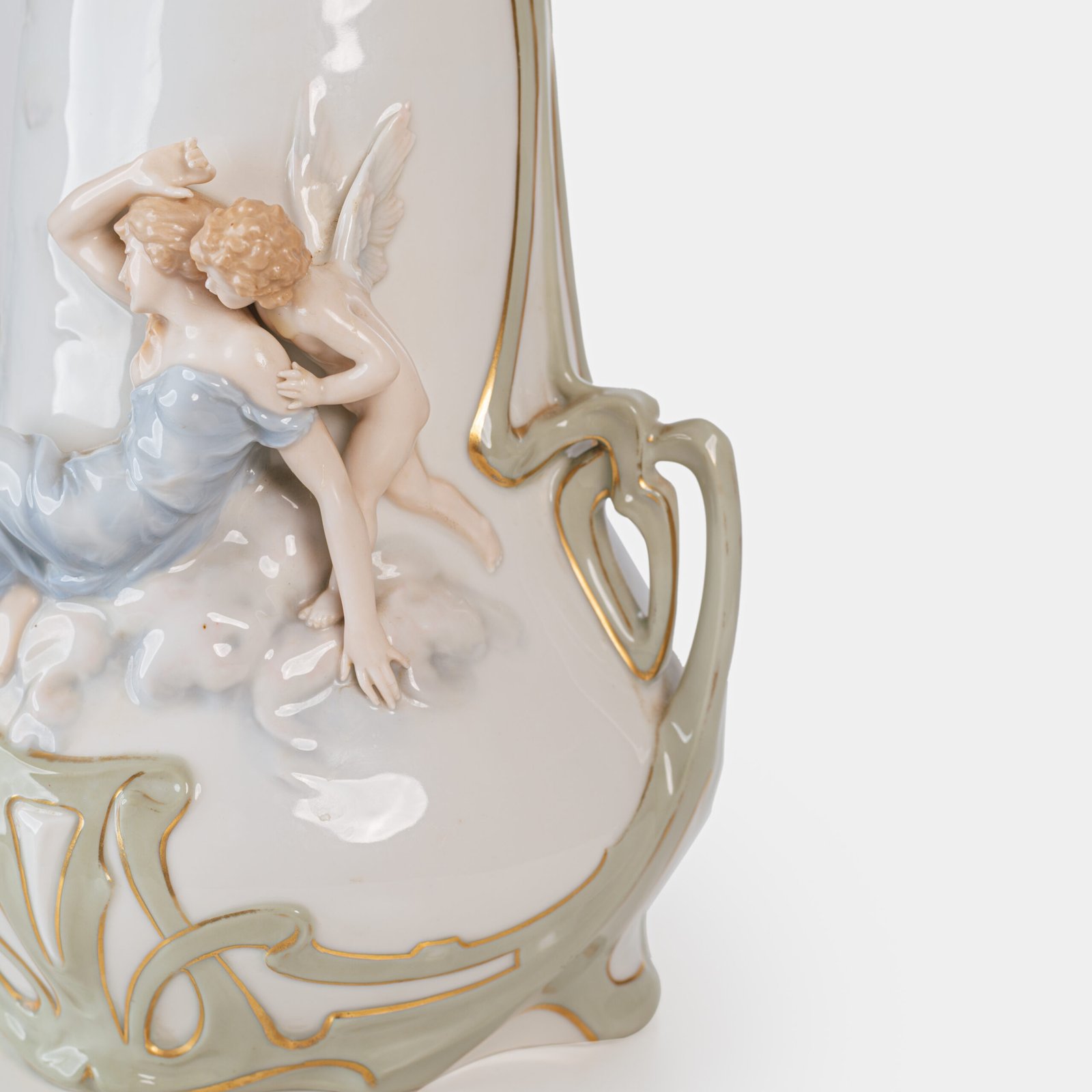 Art Nouveau porcelain vase by Karl Ens, circa 1900, featuring a sculptural composition in high relief with a maiden and cherub, hand-painted with floral details and highlighted with gilding. Marked “KVE” on the base.