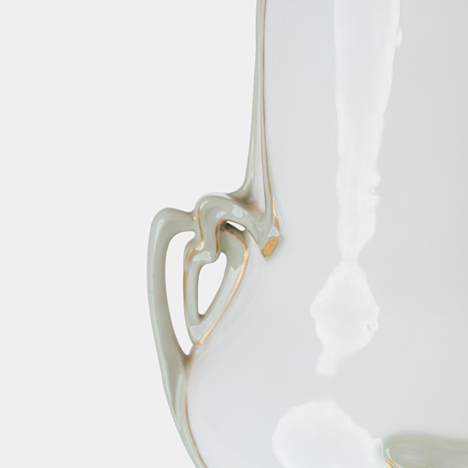 Art Nouveau porcelain vase by Karl Ens, circa 1900, featuring a sculptural composition in high relief with a maiden and cherub, hand-painted with floral details and highlighted with gilding. Marked “KVE” on the base.