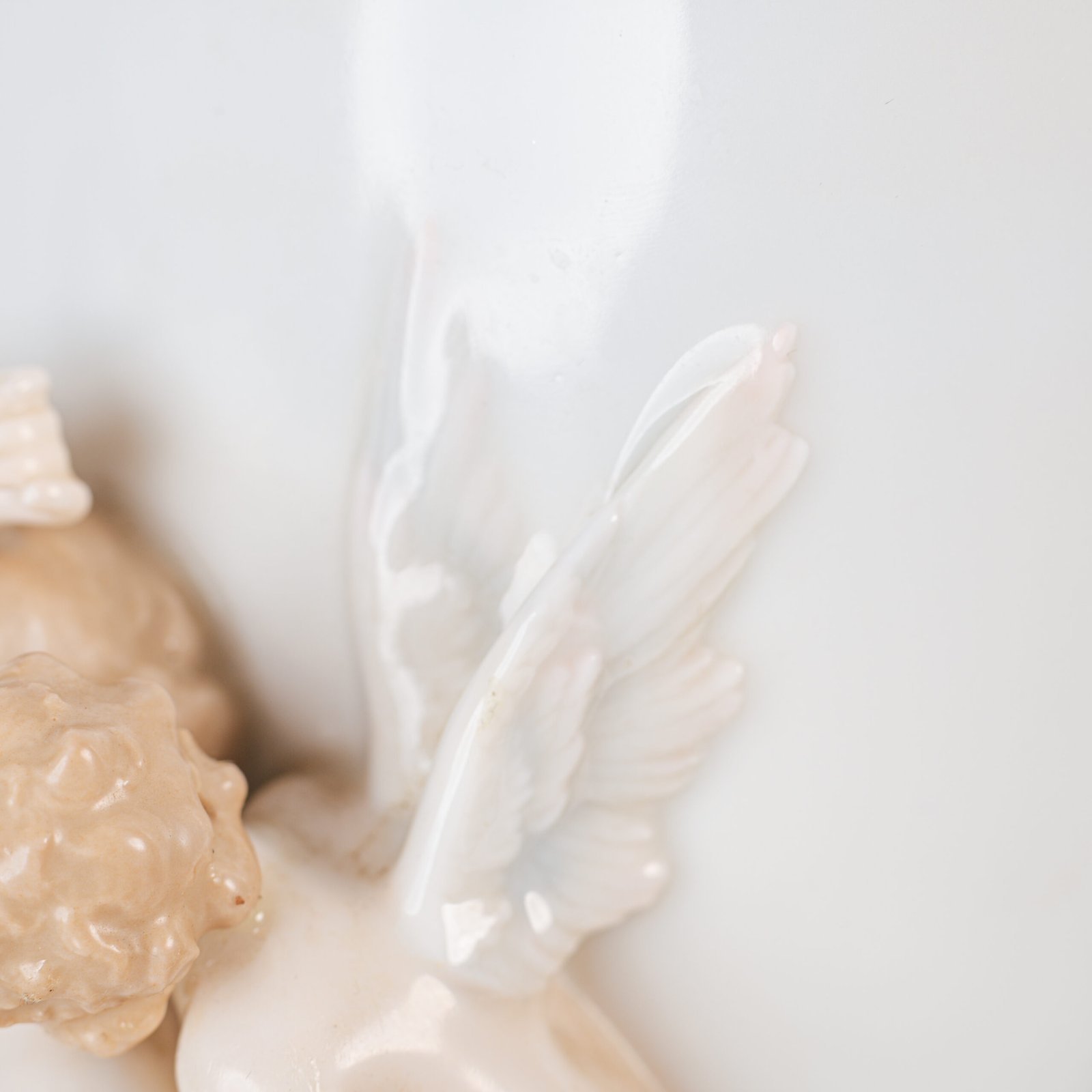 Art Nouveau porcelain vase by Karl Ens, circa 1900, featuring a sculptural composition in high relief with a maiden and cherub, hand-painted with floral details and highlighted with gilding. Marked “KVE” on the base.