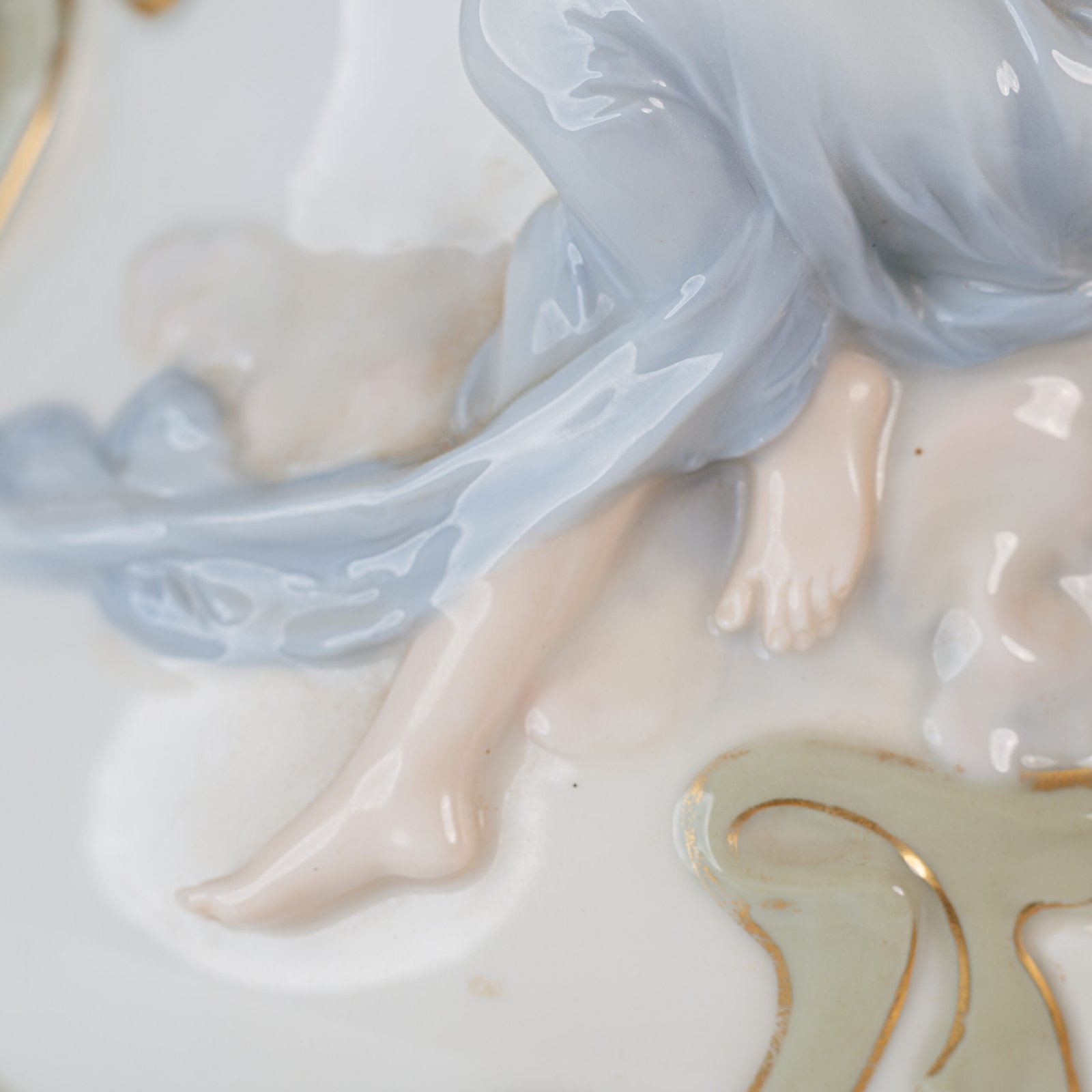 Art Nouveau porcelain vase by Karl Ens, circa 1900, featuring a sculptural composition in high relief with a maiden and cherub, hand-painted with floral details and highlighted with gilding. Marked “KVE” on the base.