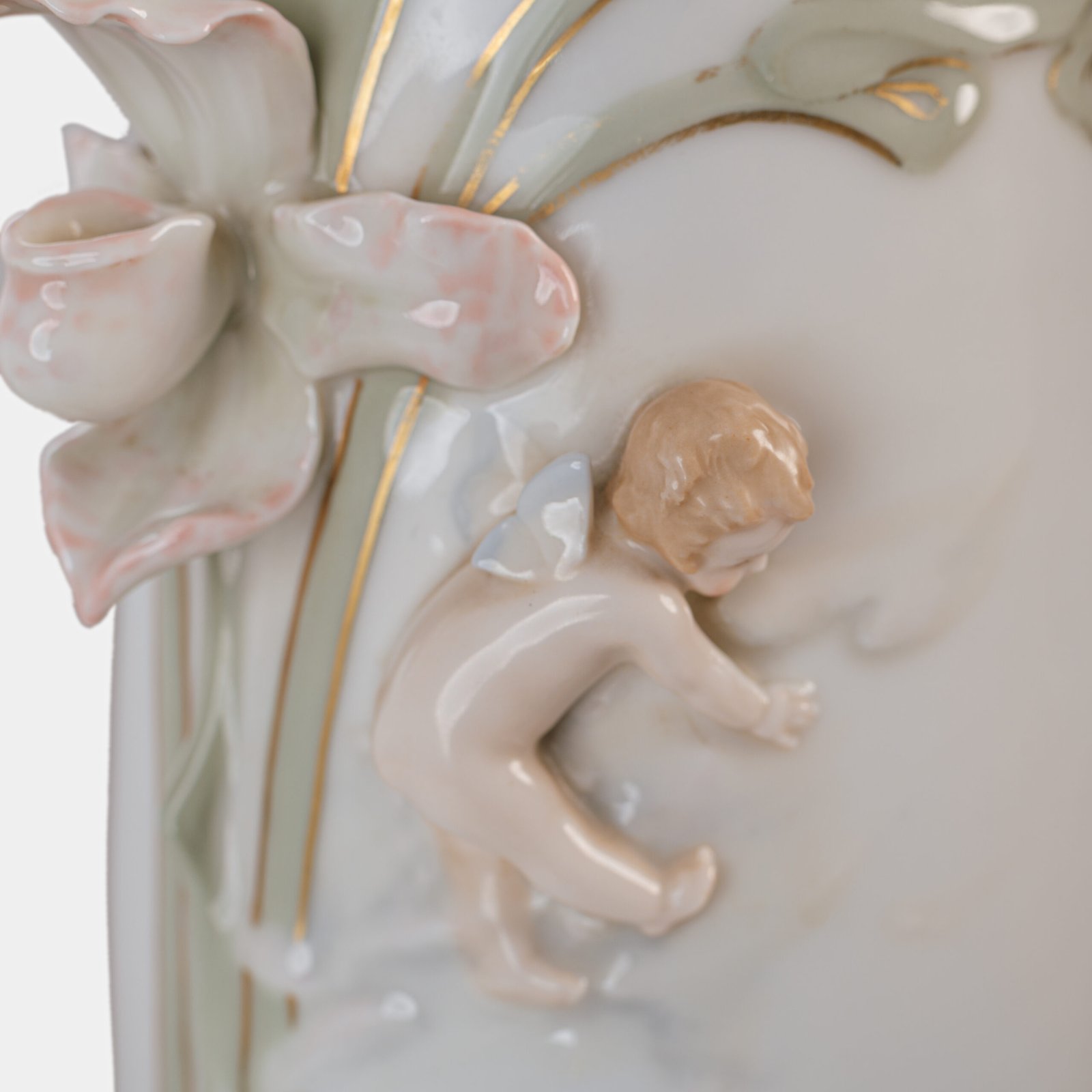 Art Nouveau porcelain vase by Karl Ens, circa 1900, featuring a sculptural composition in high relief with a maiden and cherub, hand-painted with floral details and highlighted with gilding. Marked “KVE” on the base.