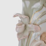 Art Nouveau porcelain vase by Karl Ens, circa 1900, featuring a sculptural composition in high relief with a maiden and cherub, hand-painted with floral details and highlighted with gilding. Marked “KVE” on the base.