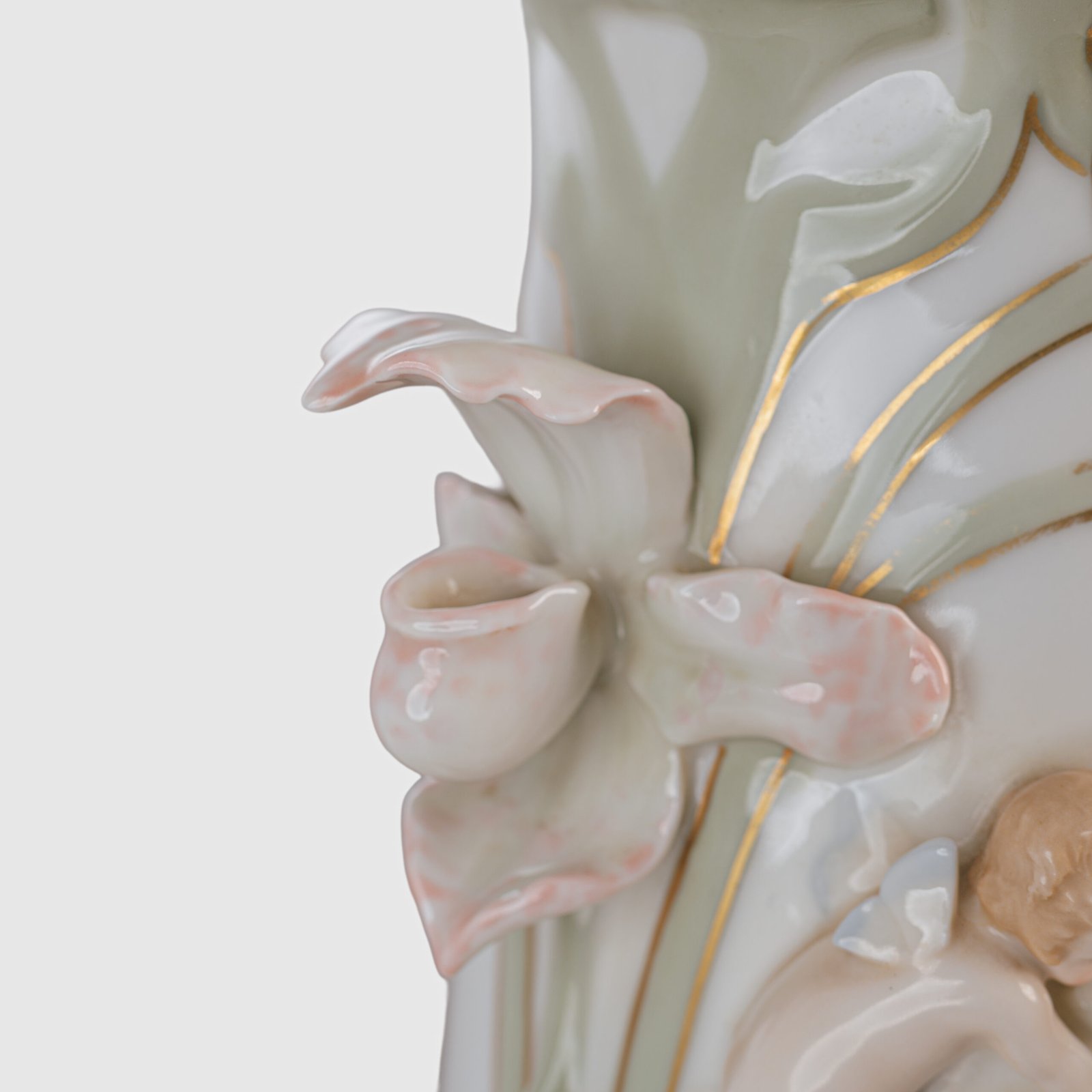 Art Nouveau porcelain vase by Karl Ens, circa 1900, featuring a sculptural composition in high relief with a maiden and cherub, hand-painted with floral details and highlighted with gilding. Marked “KVE” on the base.
