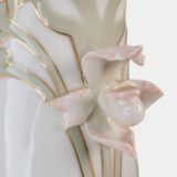 Art Nouveau porcelain vase by Karl Ens, circa 1900, featuring a sculptural composition in high relief with a maiden and cherub, hand-painted with floral details and highlighted with gilding. Marked “KVE” on the base.