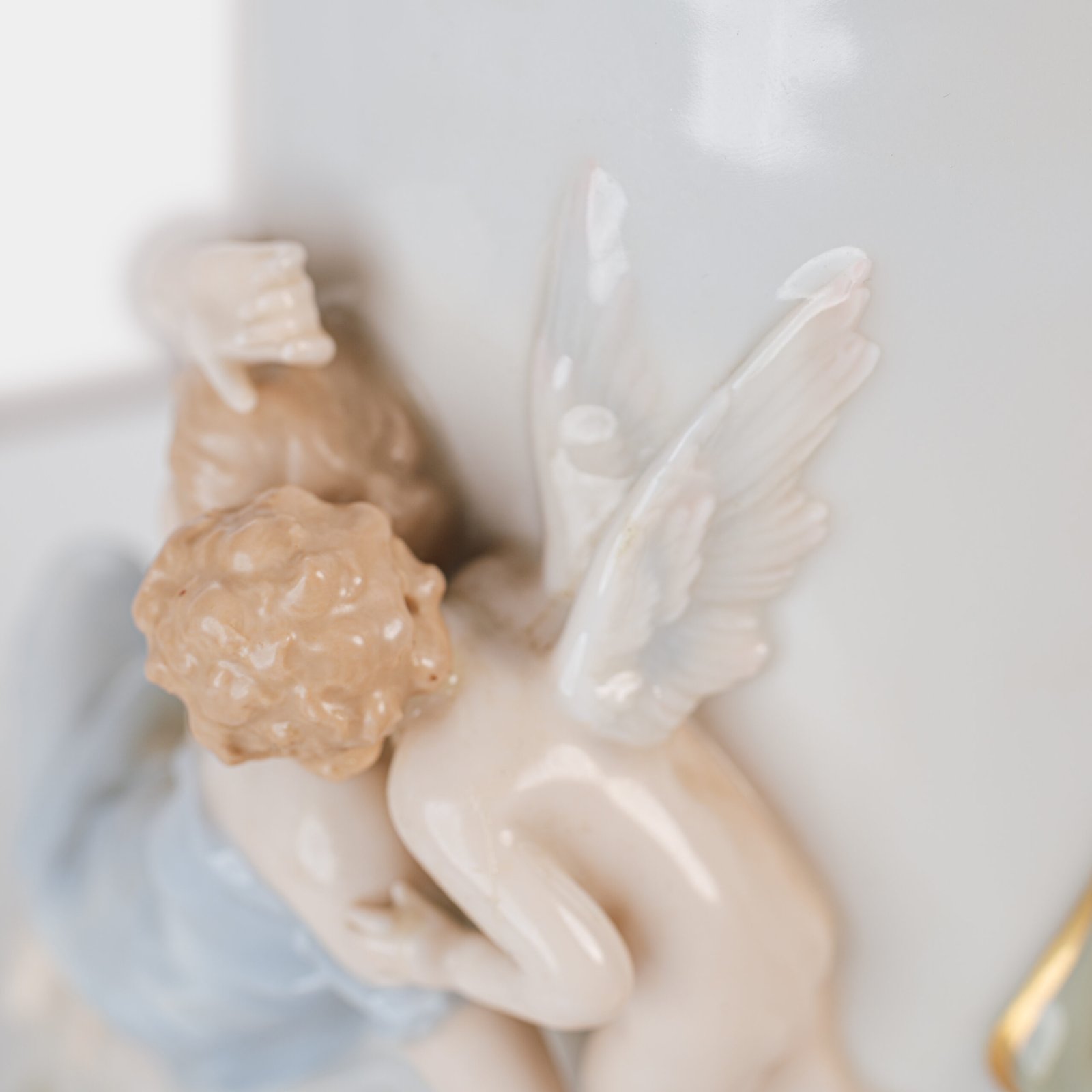 Art Nouveau porcelain vase by Karl Ens, circa 1900, featuring a sculptural composition in high relief with a maiden and cherub, hand-painted with floral details and highlighted with gilding. Marked “KVE” on the base.