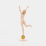 Karl Tutter porcelain figurine “Sonnenkind” – Art Deco sculpture by Hutschenreuther Germany, c.1935–1940 Art Deco porcelain figurine titled “Sonnenkind” (“Sun Child”), modeled by Karl Tutter for Hutschenreuther ca. 1935–1940. Depicts a nude young woman balancing on a golden sphere, arms extended in a dynamic pose. White porcelain with a matte pinkish flesh-tone finish, painted facial features, and satin brown hair. Gilded accents on the sphere and base. Rare signed version with circular base and gold trim.