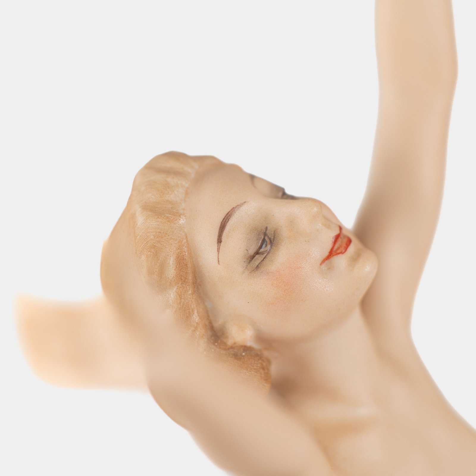 Karl Tutter porcelain figurine “Sonnenkind” – Art Deco sculpture by Hutschenreuther Germany, c.1935–1940 Art Deco porcelain figurine titled “Sonnenkind” (“Sun Child”), modeled by Karl Tutter for Hutschenreuther ca. 1935–1940. Depicts a nude young woman balancing on a golden sphere, arms extended in a dynamic pose. White porcelain with a matte pinkish flesh-tone finish, painted facial features, and satin brown hair. Gilded accents on the sphere and base. Rare signed version with circular base and gold trim.
