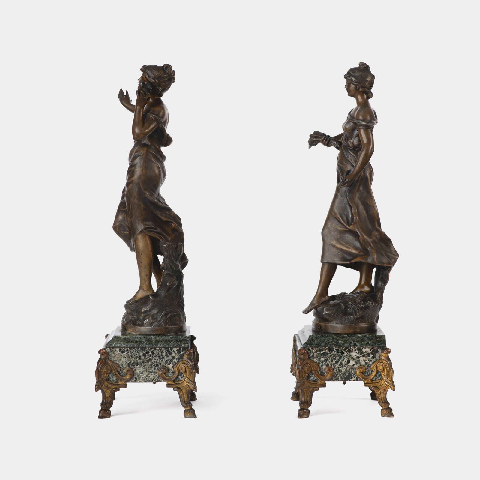 "Pair of Art Nouveau sculptures by Auguste Moreau, La Moisson and Le Message, in zinc with a bronze patina on a marble base, circa 1880-1900."