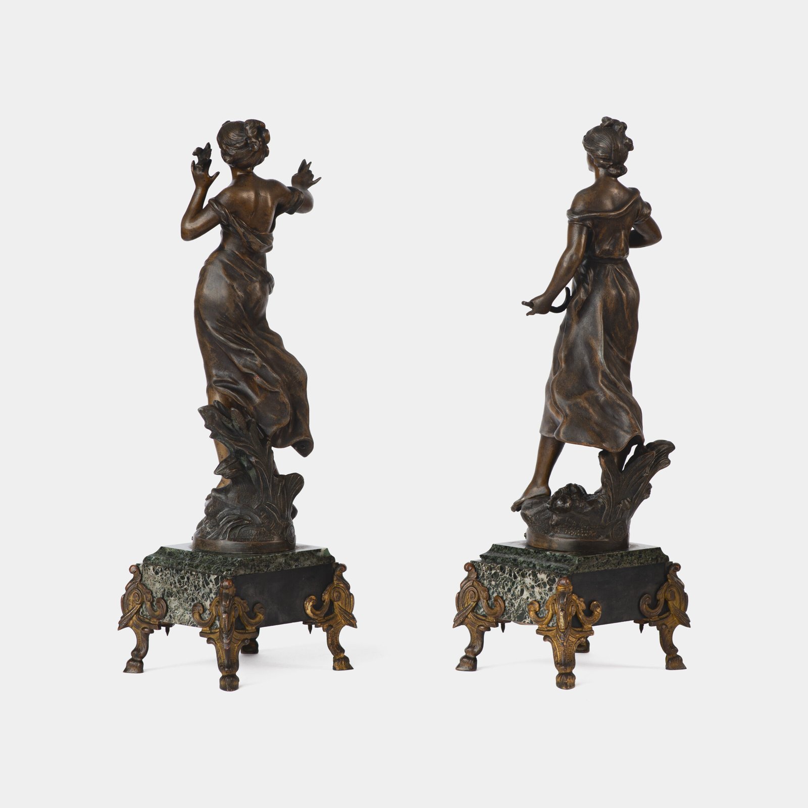 "Pair of Art Nouveau sculptures by Auguste Moreau, La Moisson and Le Message, in zinc with a bronze patina on a marble base, circa 1880-1900."
