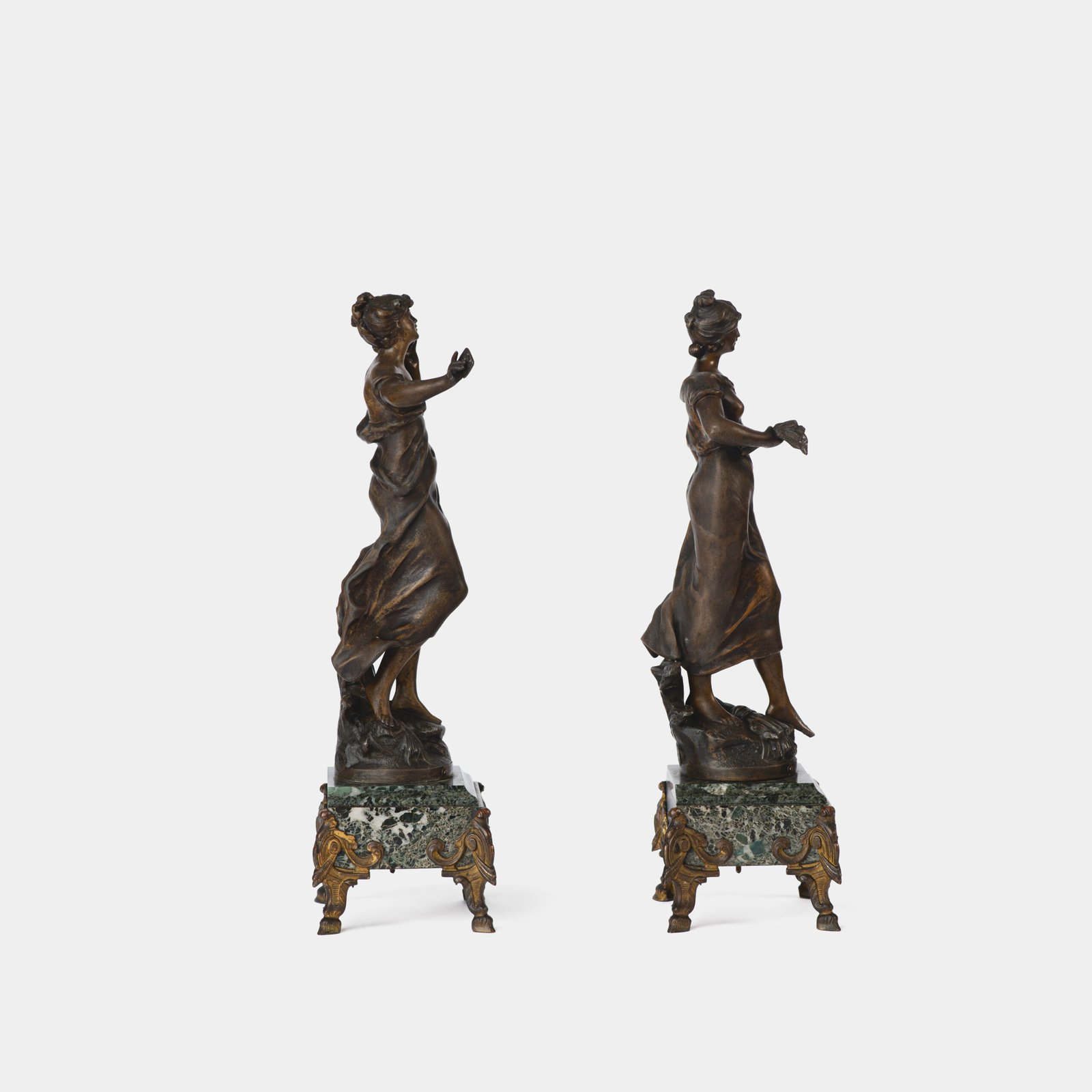 "Pair of Art Nouveau sculptures by Auguste Moreau, La Moisson and Le Message, in zinc with a bronze patina on a marble base, circa 1880-1900."