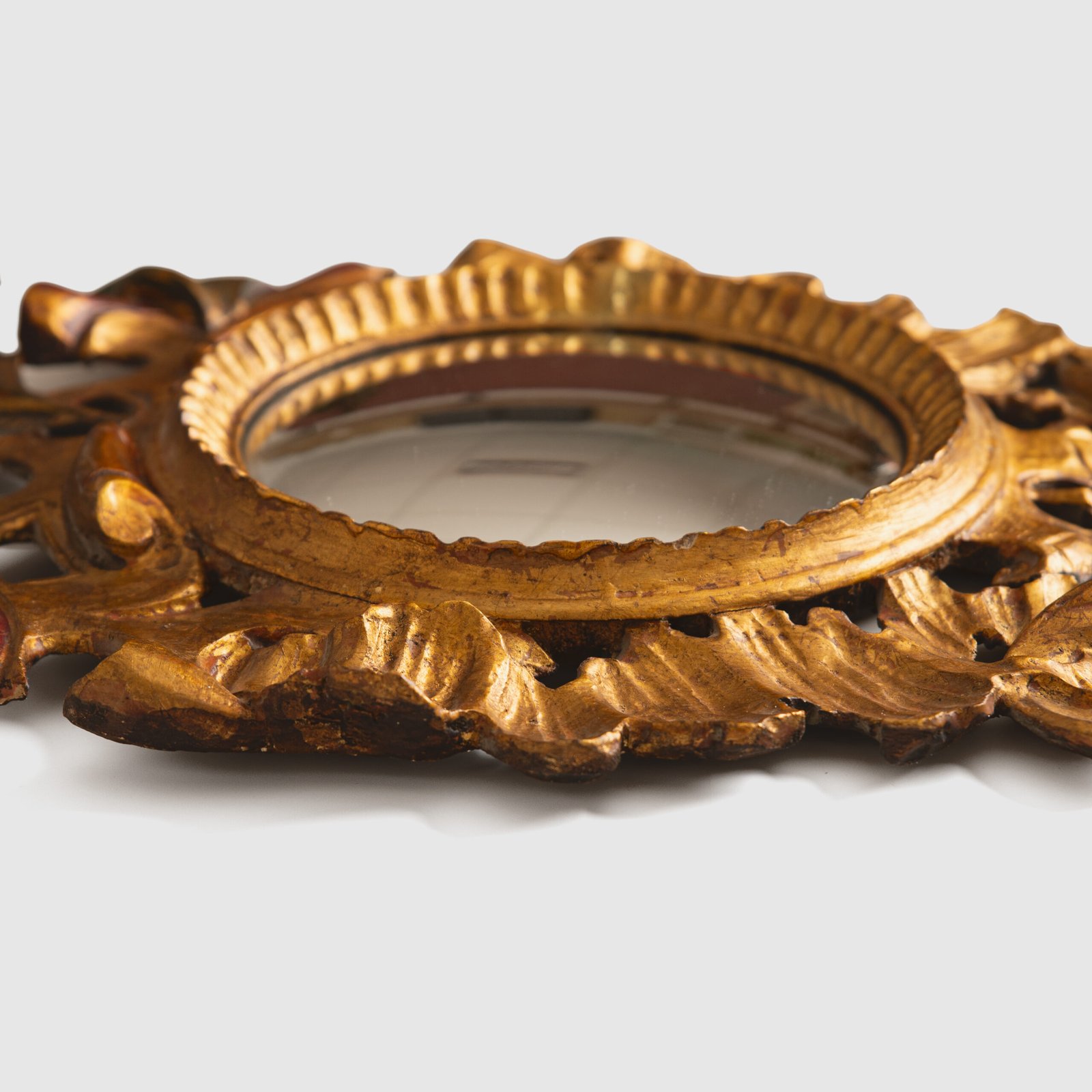 French convex mirror with gilt carved frame and original convex glass (c.1880–1920)