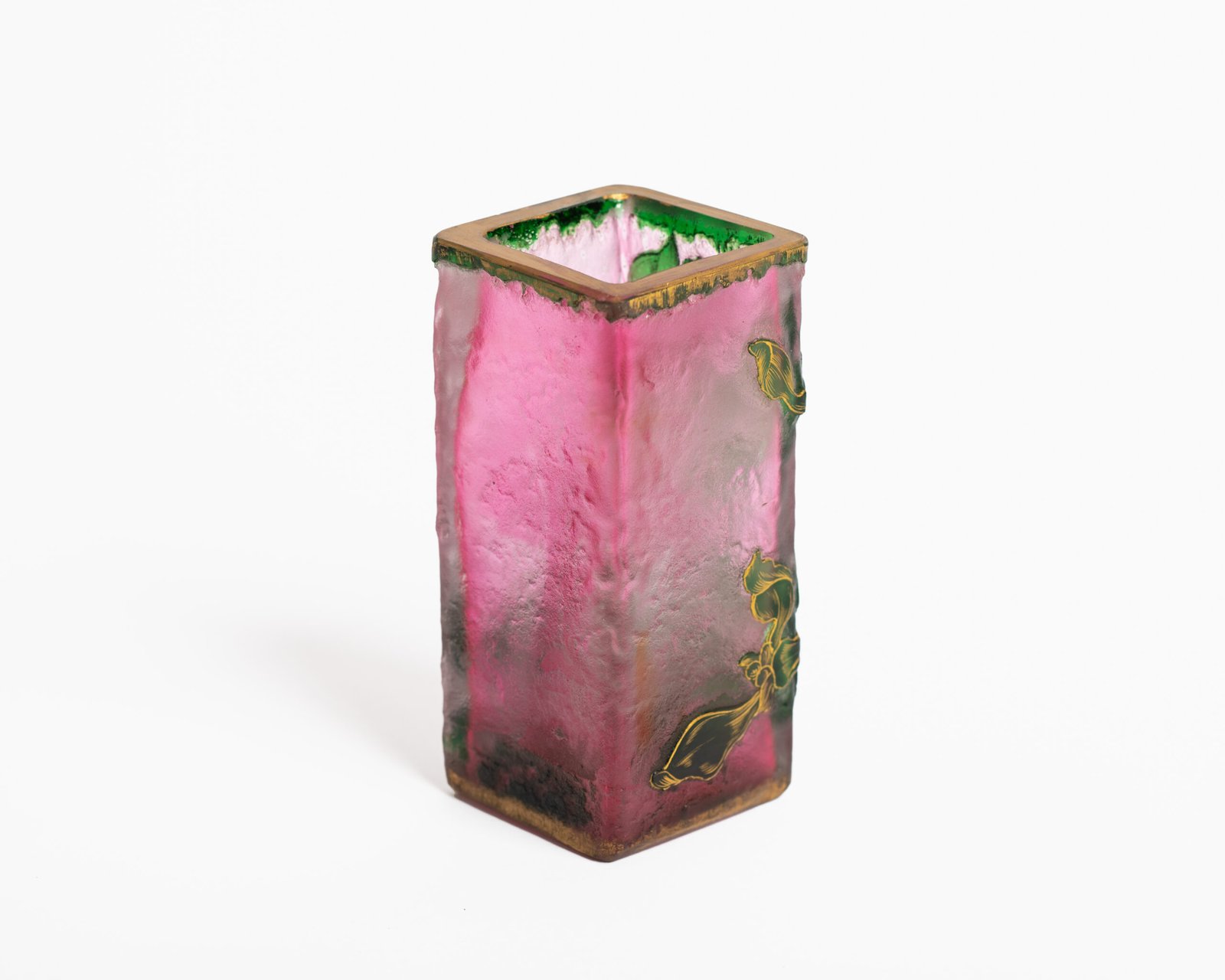 Daum (Nancy) Art Nouveau vase in pink acid-etched (frosted) glass with painted green floral decoration and gold enamel details; signed in gold with the Cross of Lorraine. Dimensions: 4.52 in (11.5 cm) high × 2.16 in (5.5 cm) wide × 2.16 in (5.5 cm) deep. Excellent condition, no chips; representative example of French art-glass production, c. 1900–1920, suitable for collections and interior design projects.