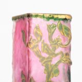 Daum (Nancy) Art Nouveau vase in pink acid-etched (frosted) glass with painted green floral decoration and gold enamel details; signed in gold with the Cross of Lorraine. Dimensions: 4.52 in (11.5 cm) high × 2.16 in (5.5 cm) wide × 2.16 in (5.5 cm) deep. Excellent condition, no chips; representative example of French art-glass production, c. 1900–1920, suitable for collections and interior design projects.