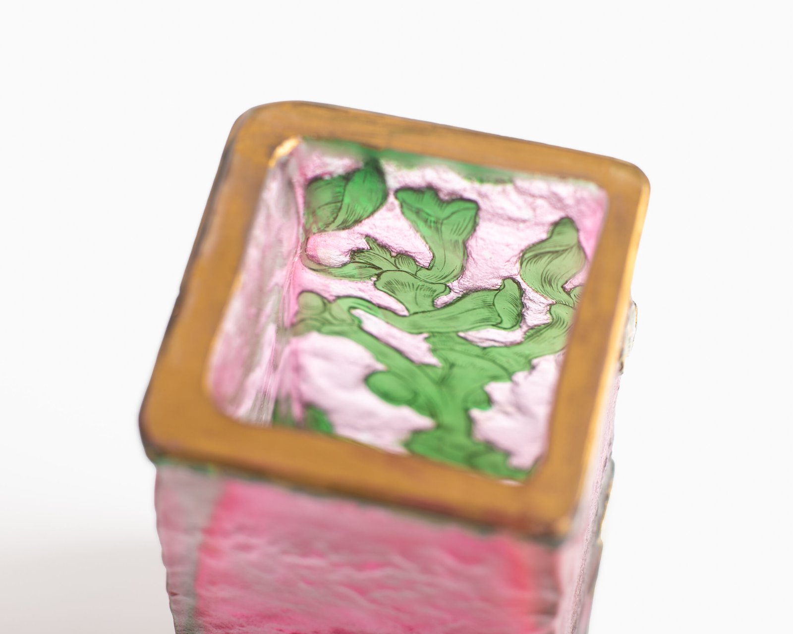 Daum (Nancy) Art Nouveau vase in pink acid-etched (frosted) glass with painted green floral decoration and gold enamel details; signed in gold with the Cross of Lorraine. Dimensions: 4.52 in (11.5 cm) high × 2.16 in (5.5 cm) wide × 2.16 in (5.5 cm) deep. Excellent condition, no chips; representative example of French art-glass production, c. 1900–1920, suitable for collections and interior design projects.