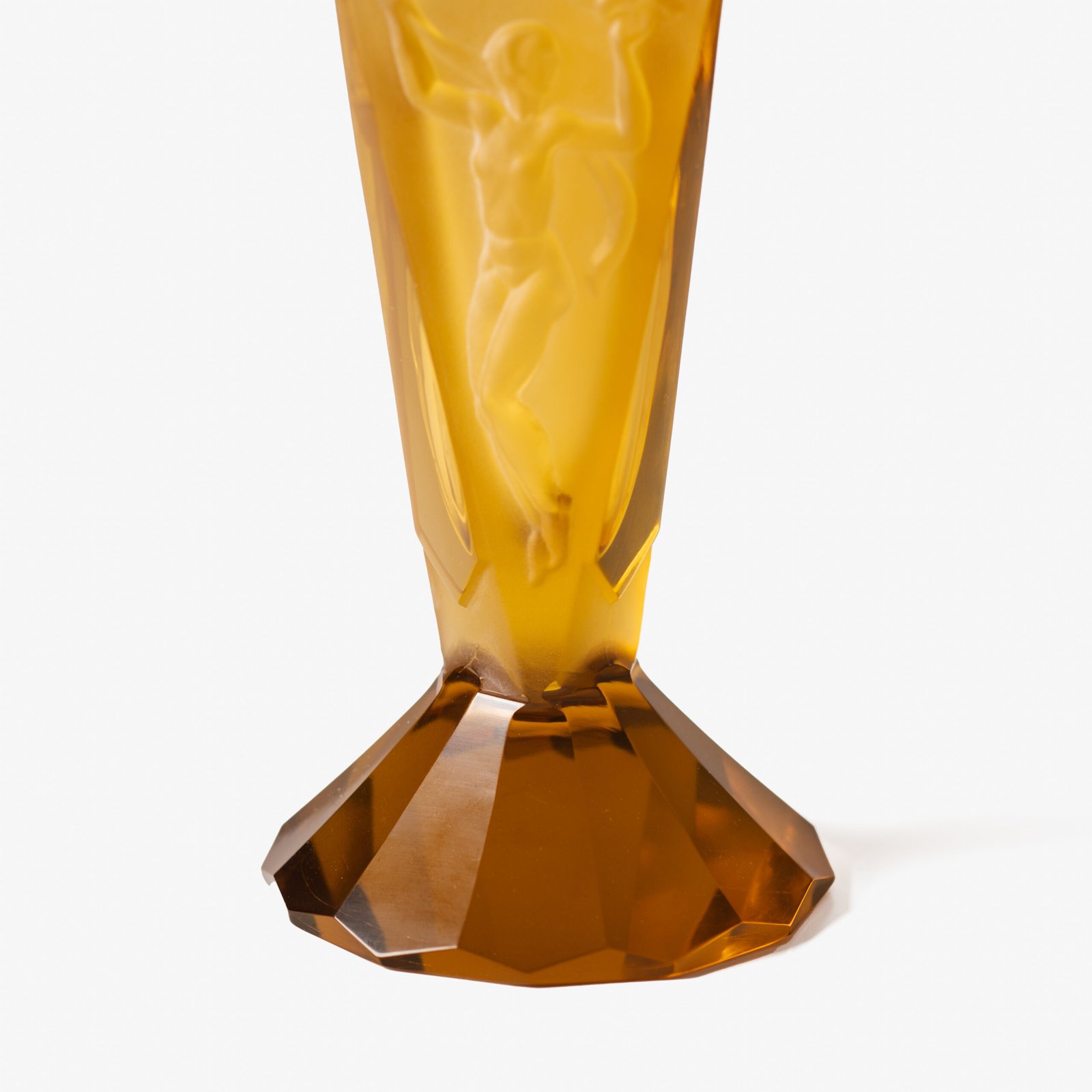 Large German Art Deco perfume bottle in satin-finished pressed amber glass, c. 1930, with figurative relief panels of nude female figures in different poses, faceted geometric base and tall fan-shaped stopper; height 29 cm / 11.42 in, width 9.5 cm / 3.74 in.