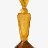 Large German Art Deco perfume bottle in satin-finished pressed amber glass, c. 1930, with figurative relief panels of nude female figures in different poses, faceted geometric base and tall fan-shaped stopper; height 29 cm / 11.42 in, width 9.5 cm / 3.74 in.
