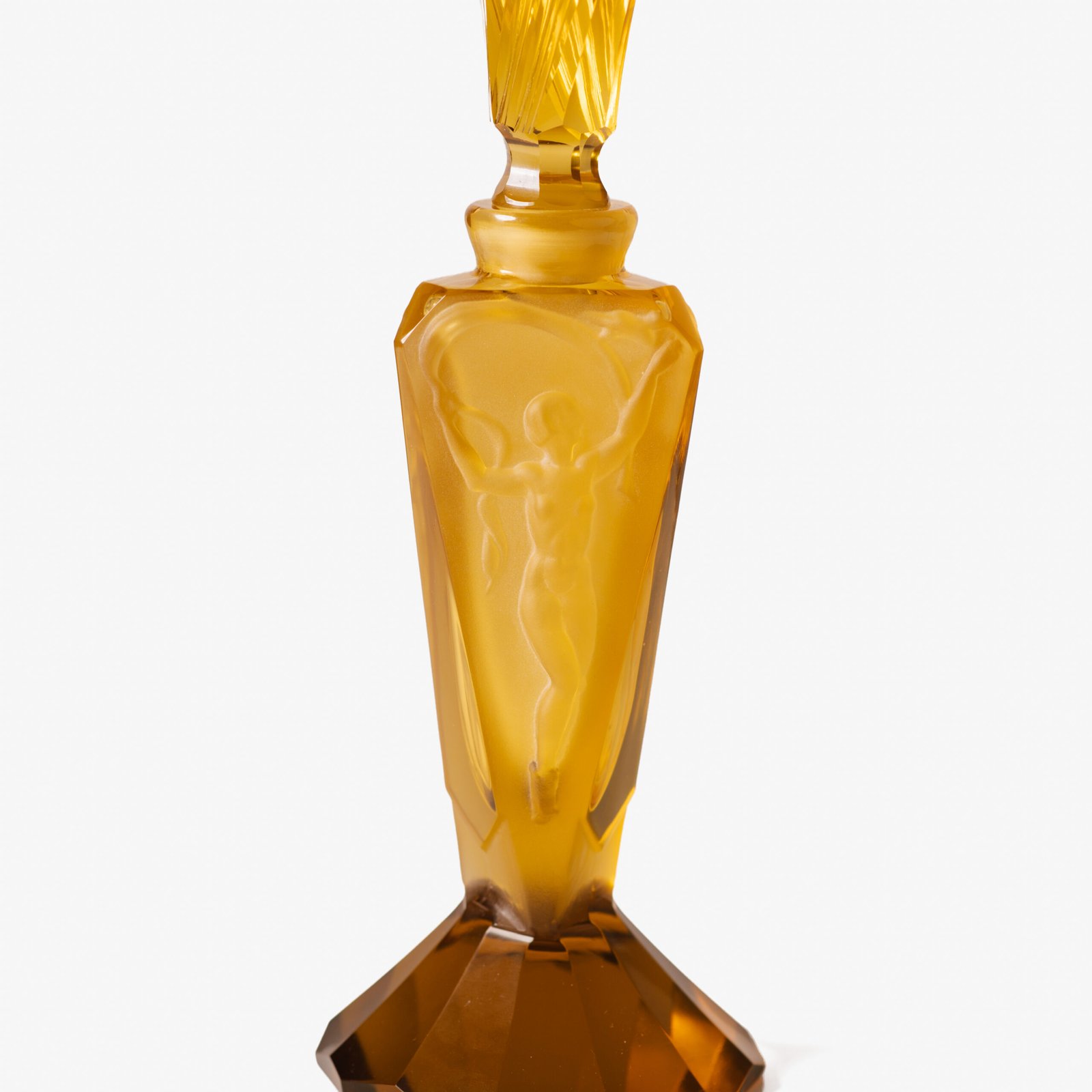 Large German Art Deco perfume bottle in satin-finished pressed amber glass, c. 1930, with figurative relief panels of nude female figures in different poses, faceted geometric base and tall fan-shaped stopper; height 29 cm / 11.42 in, width 9.5 cm / 3.74 in.