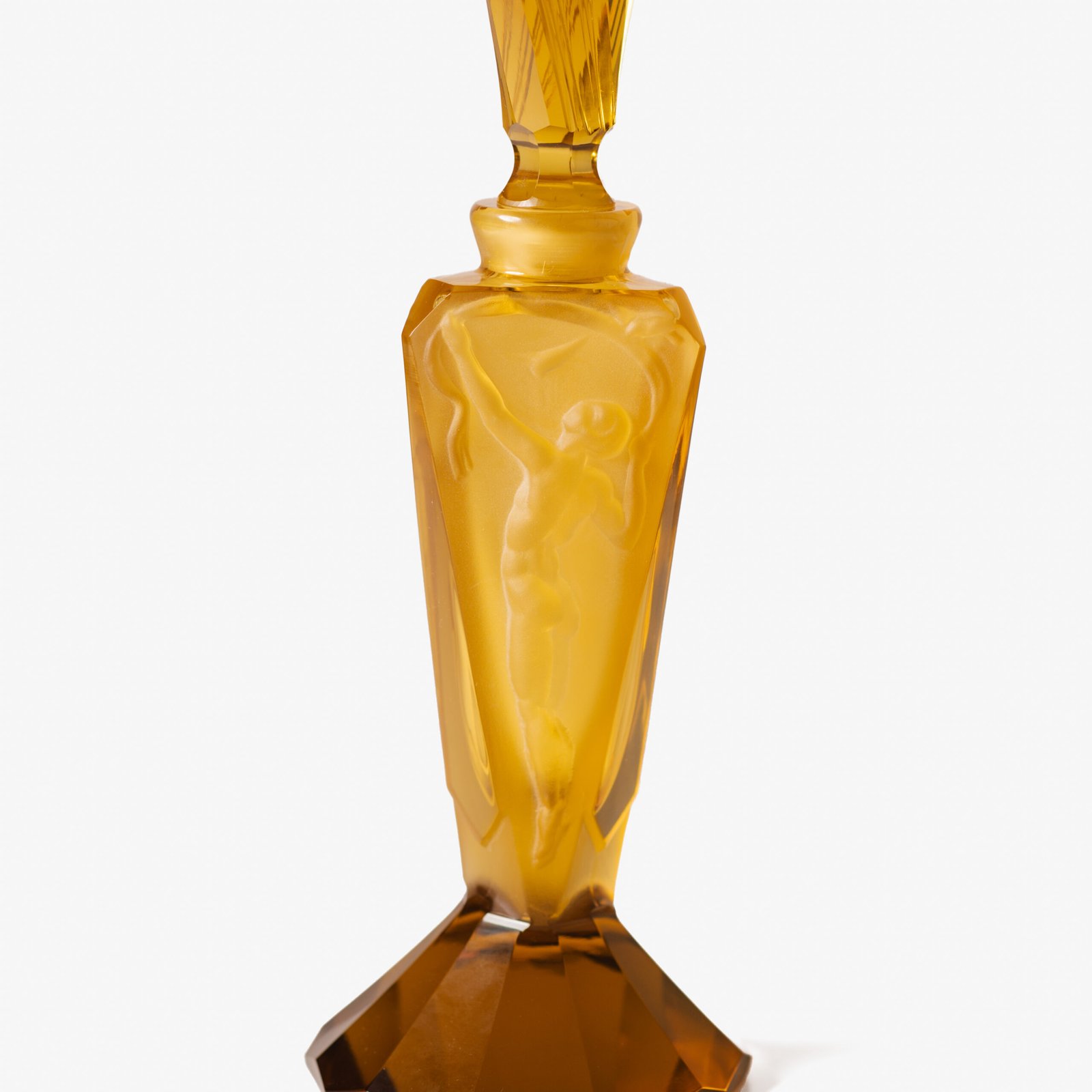 Large German Art Deco perfume bottle in satin-finished pressed amber glass, c. 1930, with figurative relief panels of nude female figures in different poses, faceted geometric base and tall fan-shaped stopper; height 29 cm / 11.42 in, width 9.5 cm / 3.74 in.