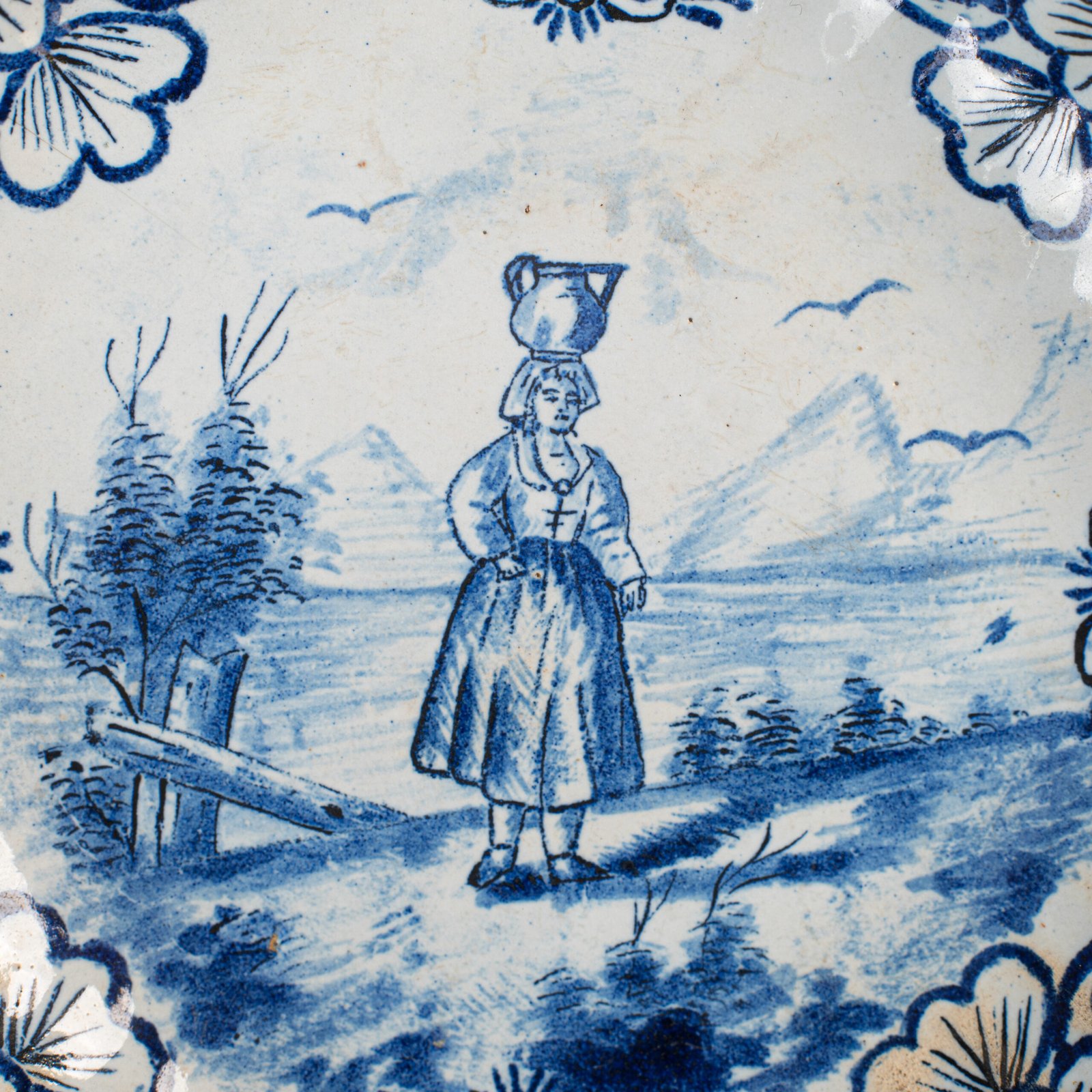 Rare 17th-century Delft blue plate by Adriaen Kocks, ca. 1686–1700, cabinet plate with finely painted rural female figure, signed AK.
