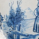 Rare 17th-century Delft blue plate by Adriaen Kocks, ca. 1686–1700, cabinet plate with finely painted rural female figure, signed AK.