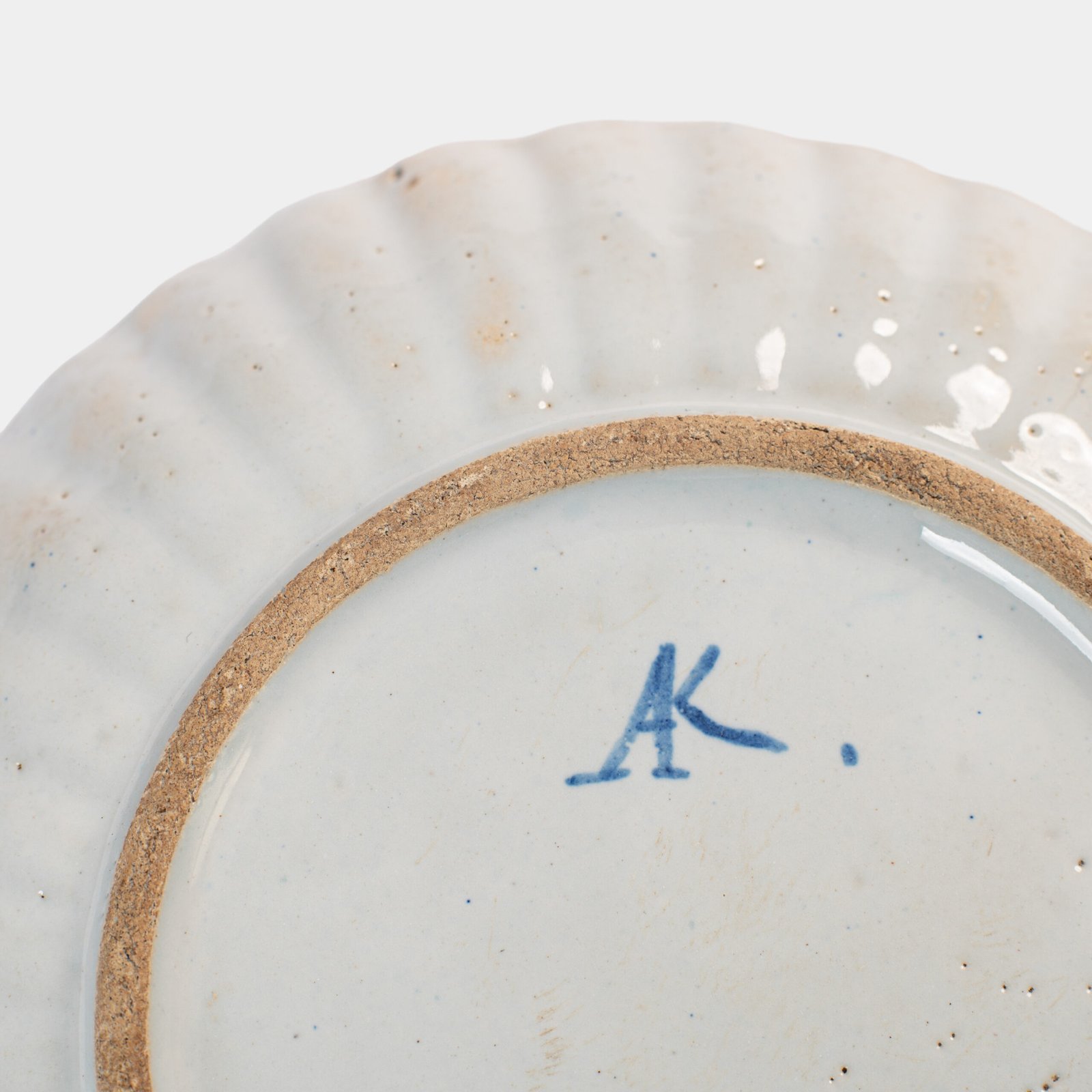 Rare 17th-century Delft blue plate by Adriaen Kocks, ca. 1686–1700, cabinet plate with finely painted rural female figure, signed AK.