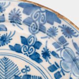 Exceptional 18th century Delft blue and white bowl-shaped plate with floral basket decoration, ca. 1700–1740, Dutch tin-glazed earthenware