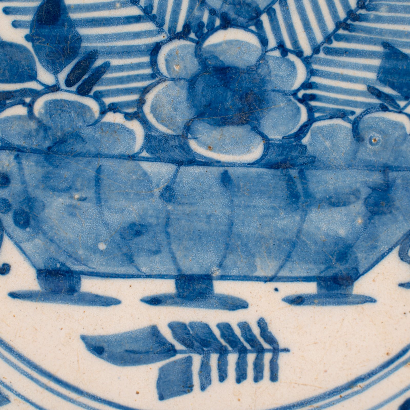 Exceptional 18th century Delft blue and white bowl-shaped plate with floral basket decoration, ca. 1700–1740, Dutch tin-glazed earthenware
