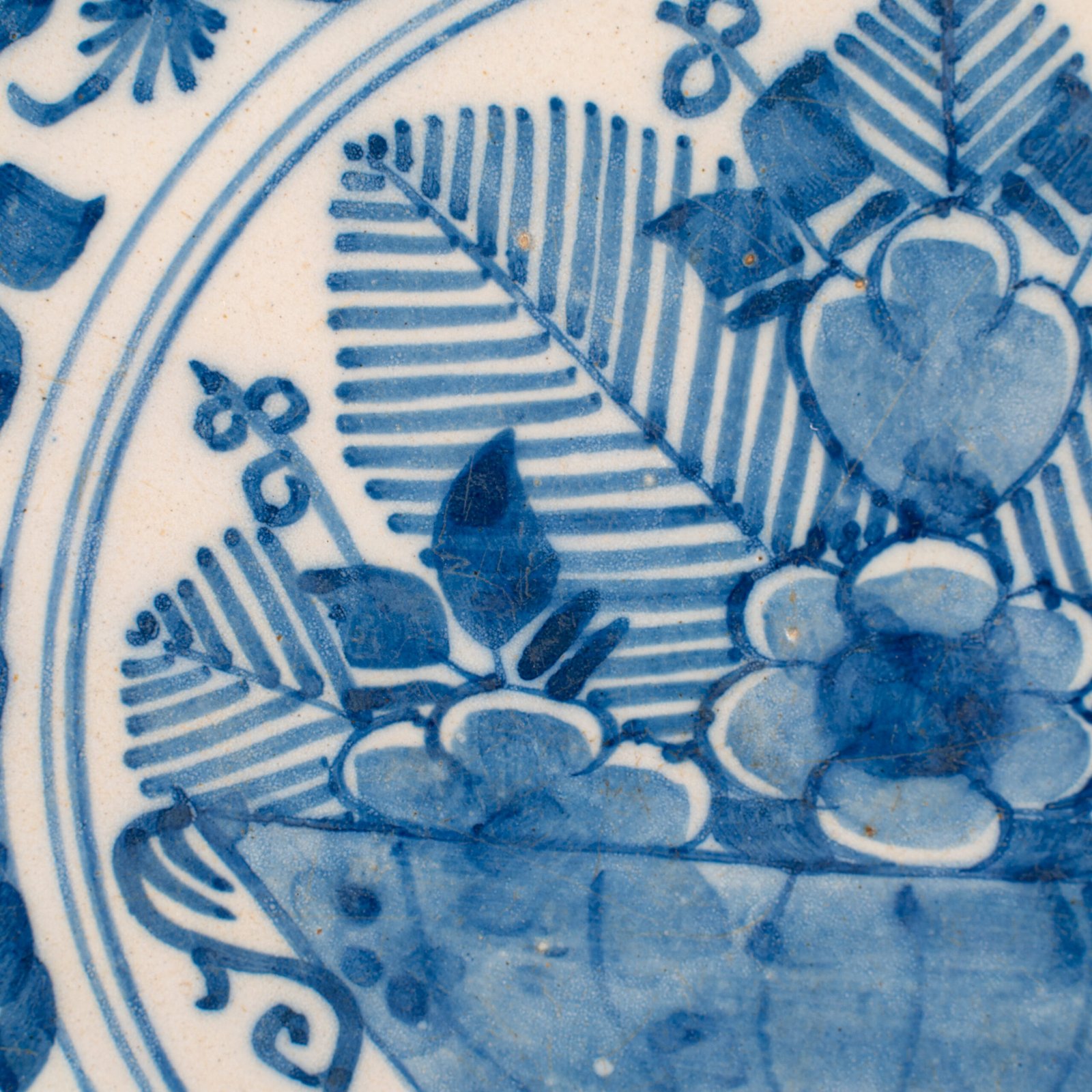 Exceptional 18th century Delft blue and white bowl-shaped plate with floral basket decoration, ca. 1700–1740, Dutch tin-glazed earthenware