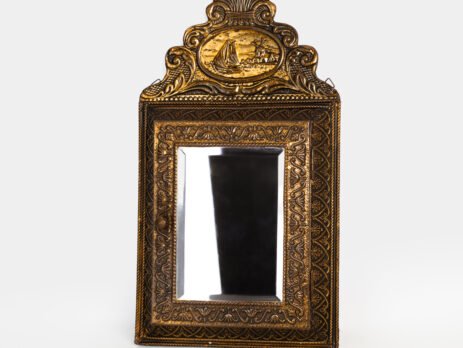 Dutch Mirror Cabinet in embossed brass with windmill motif, beveled mirror door and interior brushes, circa 1890–1920.
