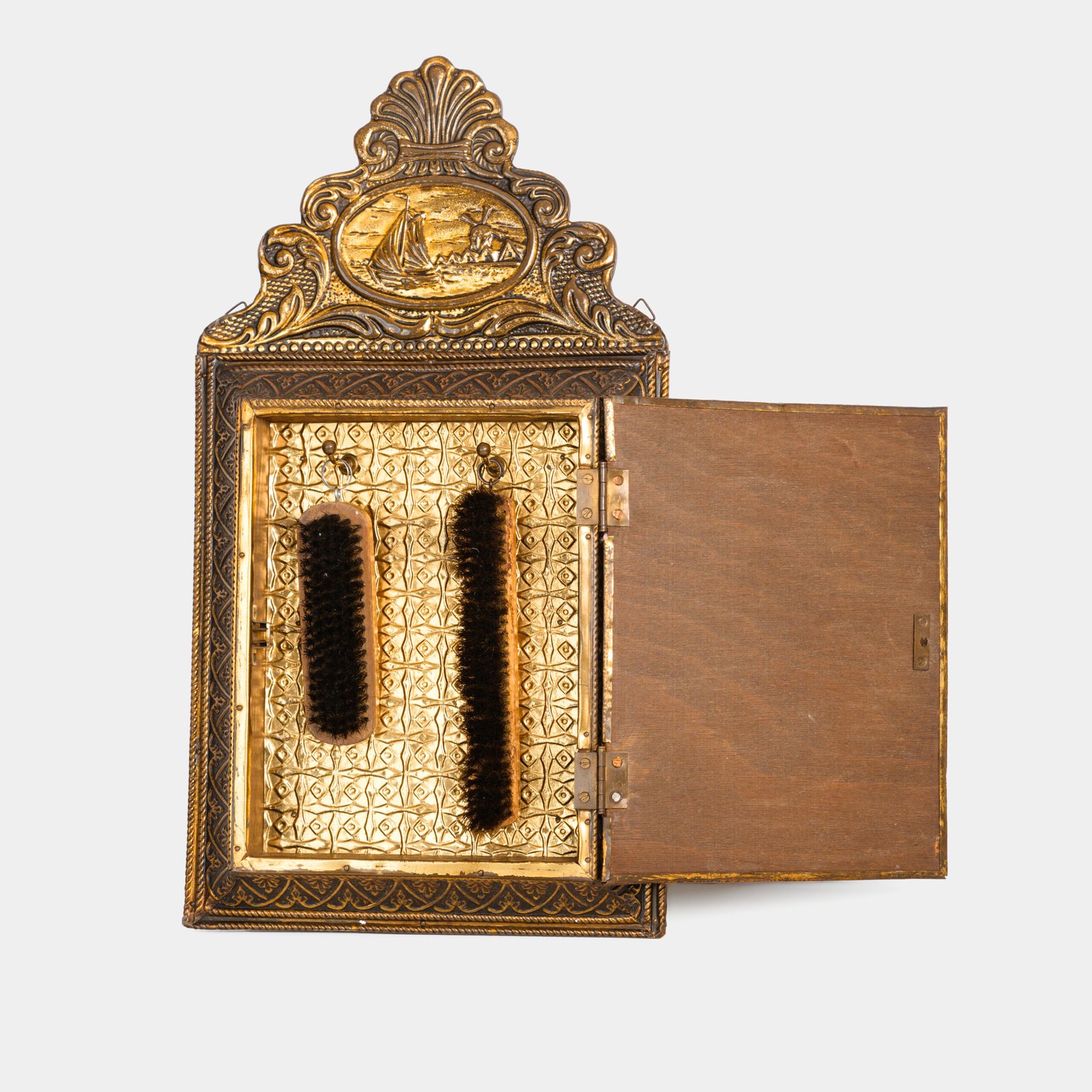 Dutch Mirror Cabinet in embossed brass with windmill motif, beveled mirror door and interior brushes, circa 1890–1920.