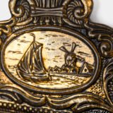 Dutch Mirror Cabinet in embossed brass with windmill motif, beveled mirror door and interior brushes, circa 1890–1920.