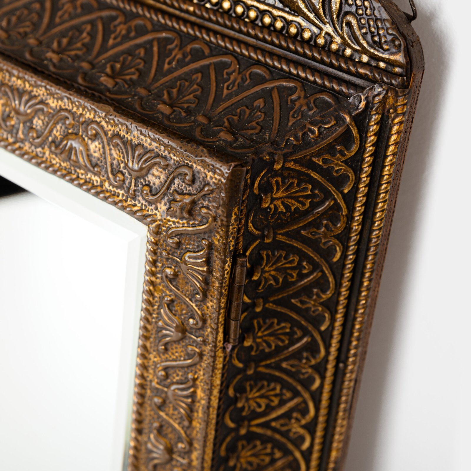 Dutch Mirror Cabinet in embossed brass with windmill motif, beveled mirror door and interior brushes, circa 1890–1920.