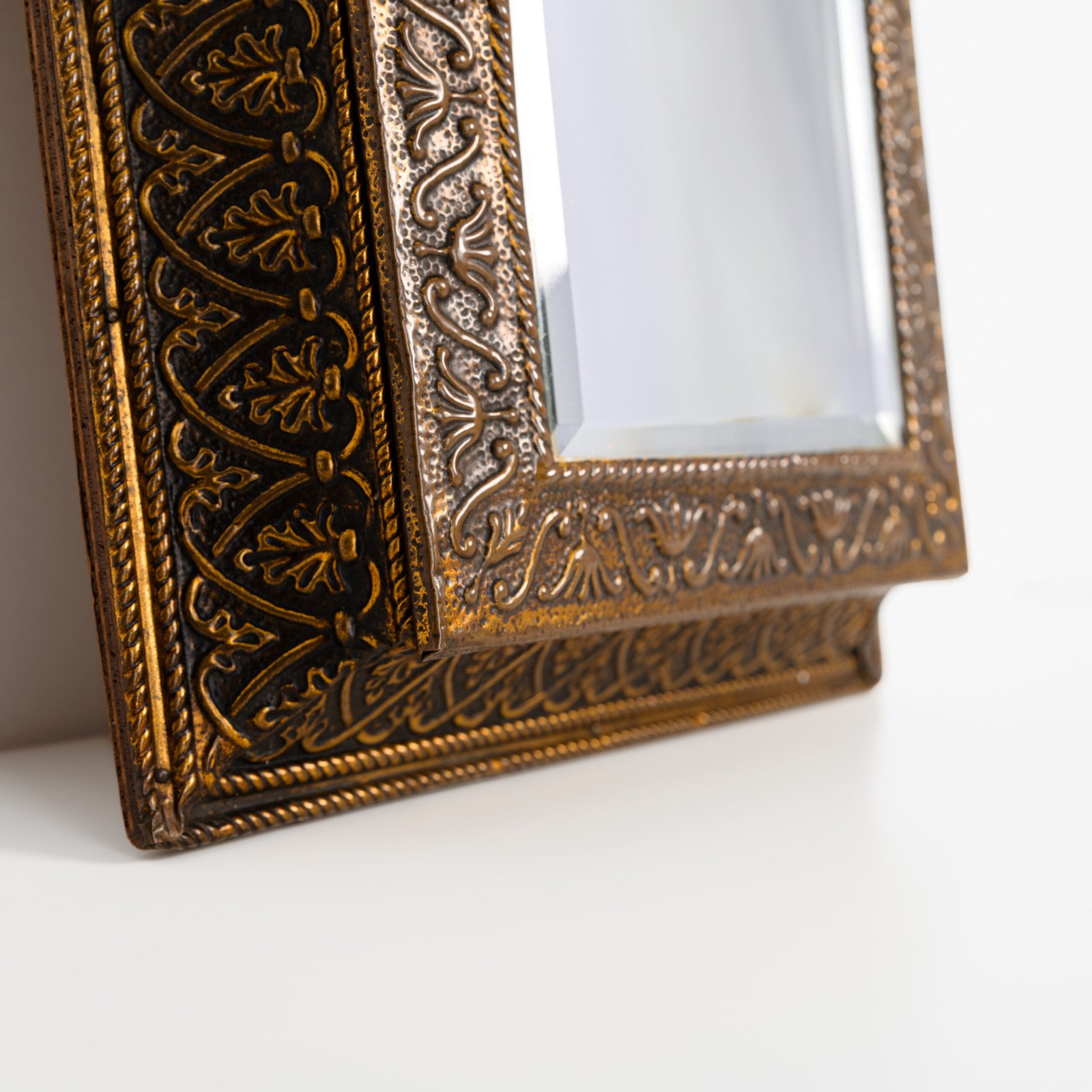 Dutch Mirror Cabinet in embossed brass with windmill motif, beveled mirror door and interior brushes, circa 1890–1920.