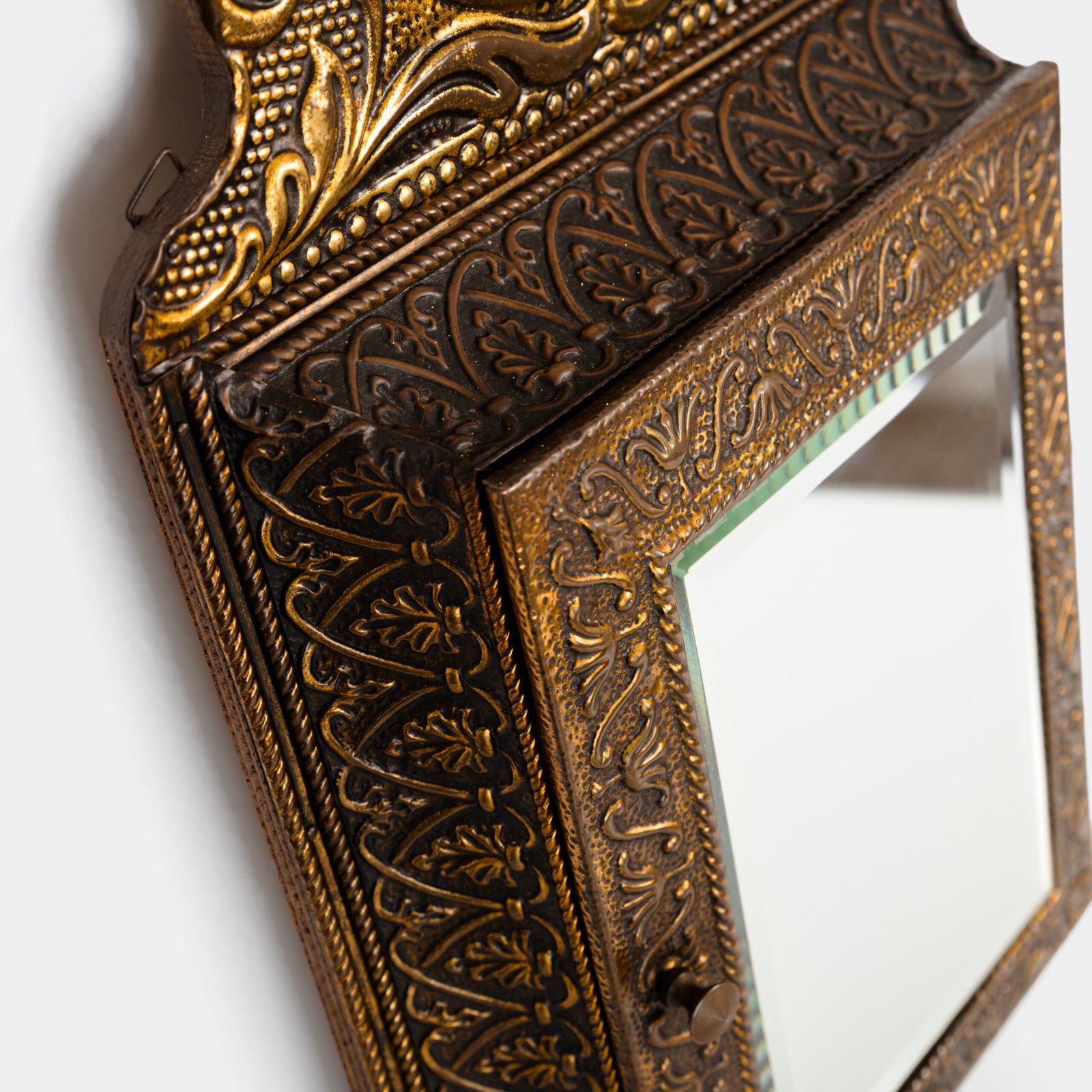Dutch Mirror Cabinet in embossed brass with windmill motif, beveled mirror door and interior brushes, circa 1890–1920.