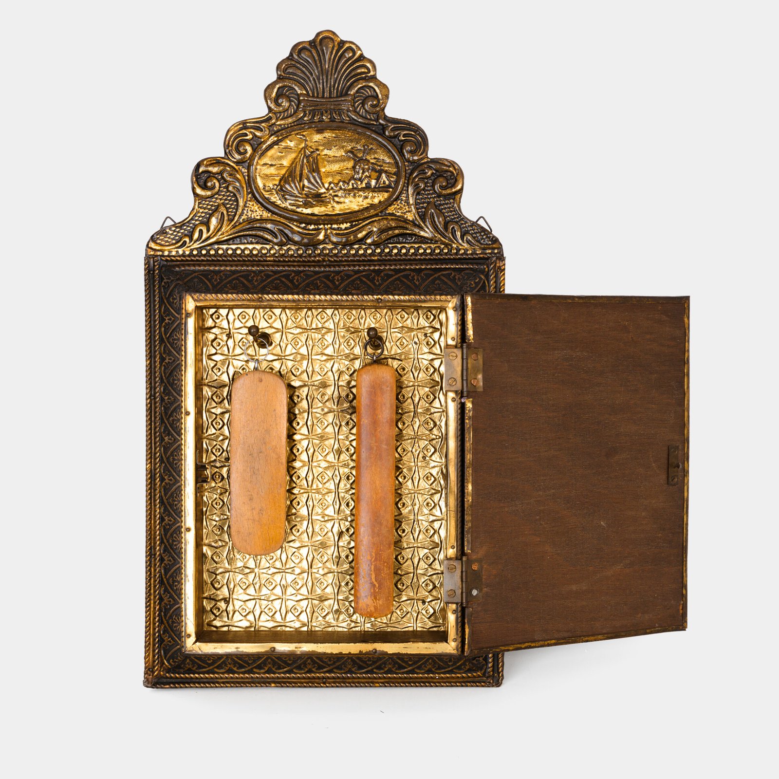 Dutch Mirror Cabinet in embossed brass with windmill motif, beveled mirror door and interior brushes, circa 1890–1920.