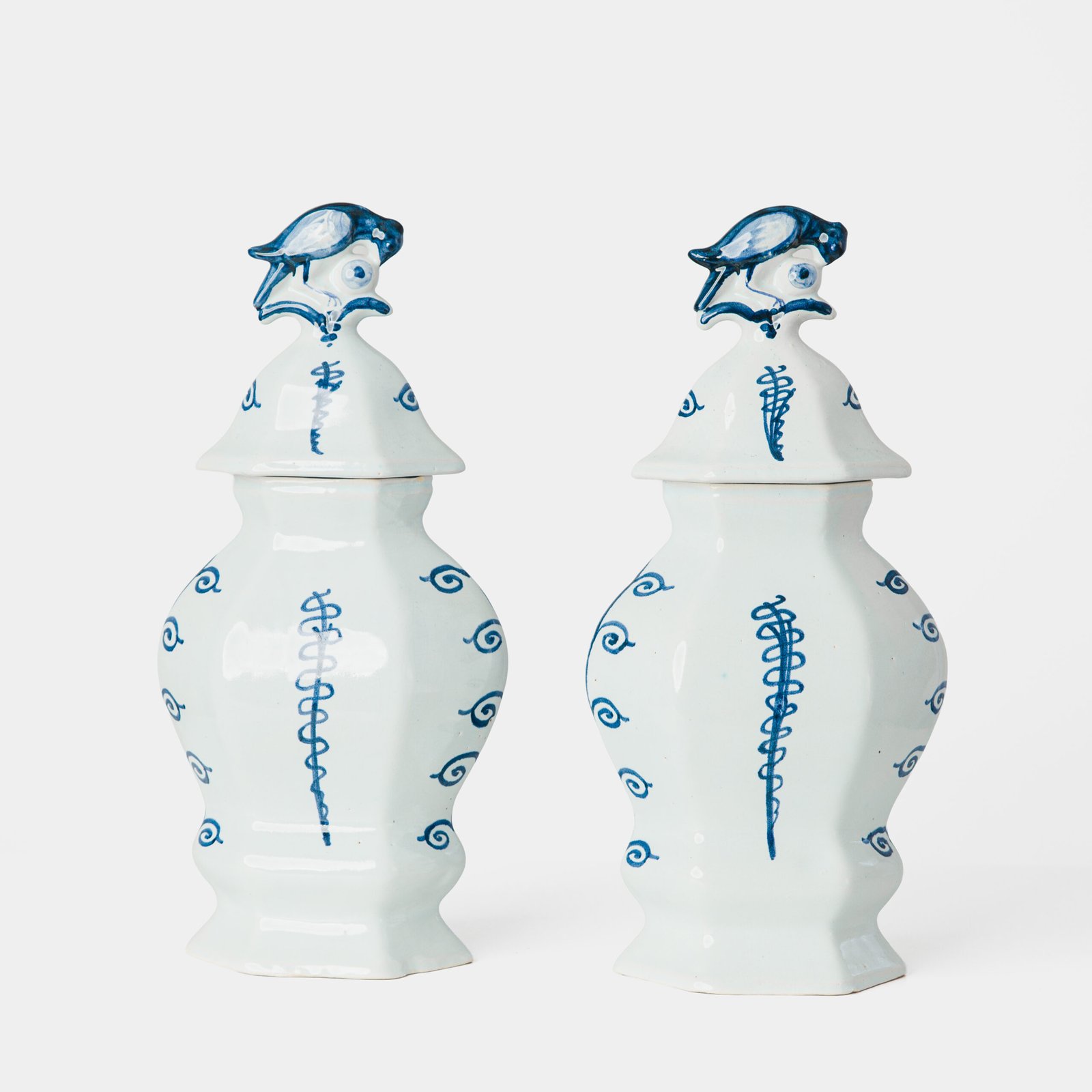 Antique Delft Vases in cobalt blue with lid and bird finial, hand-painted hexagonal bodies with Dutch scenes and blue underglaze mark on the base.