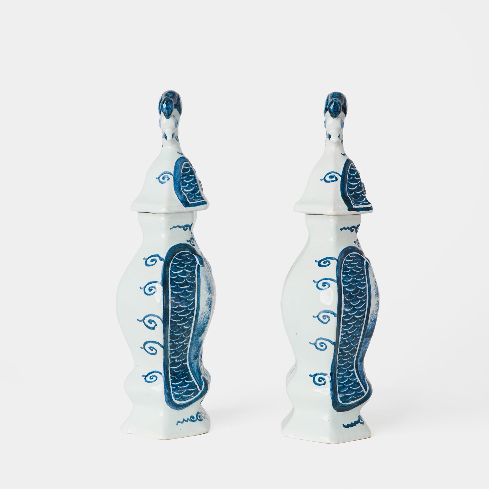 Antique Delft Vases in cobalt blue with lid and bird finial, hand-painted hexagonal bodies with Dutch scenes and blue underglaze mark on the base.