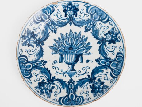 Antique Delft Plate from the early 18th century, crafted at the De Drie Porceleyne Flessies workshop, featuring the WK mark of Willem van der Kool and his widow Cornelia van Schoonhoven.