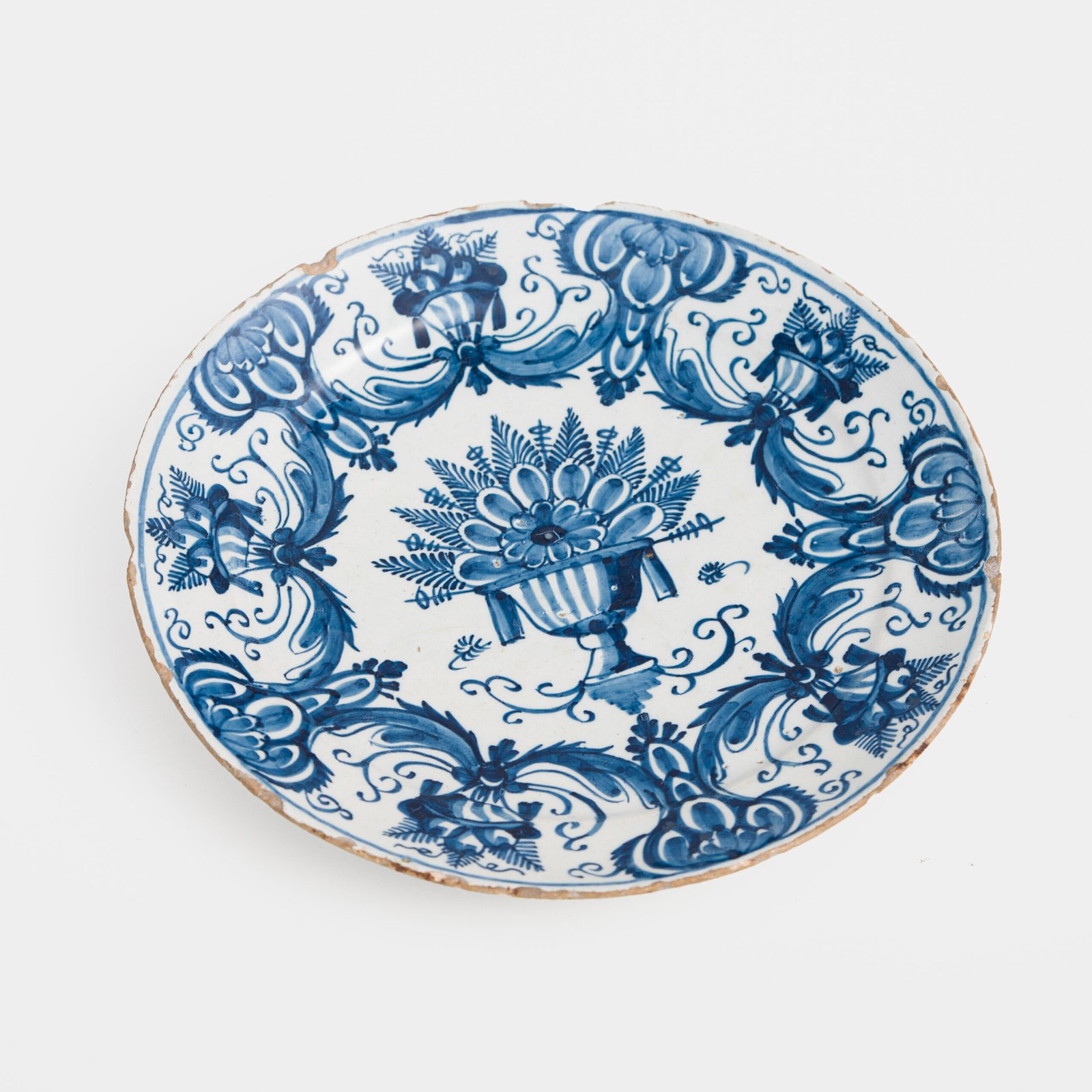 Antique Delft Plate from the early 18th century, crafted at the De Drie Porceleyne Flessies workshop, featuring the WK mark of Willem van der Kool and his widow Cornelia van Schoonhoven.