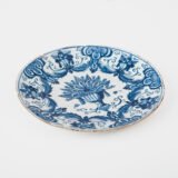 Antique Delft Plate from the early 18th century, crafted at the De Drie Porceleyne Flessies workshop, featuring the WK mark of Willem van der Kool and his widow Cornelia van Schoonhoven.