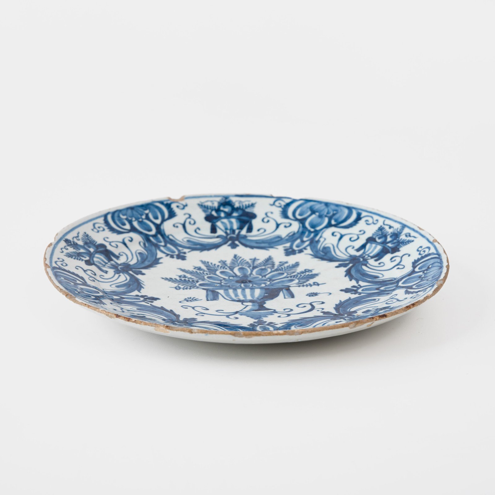 Antique Delft Plate from the early 18th century, crafted at the De Drie Porceleyne Flessies workshop, featuring the WK mark of Willem van der Kool and his widow Cornelia van Schoonhoven.