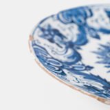 Antique Delft Plate from the early 18th century, crafted at the De Drie Porceleyne Flessies workshop, featuring the WK mark of Willem van der Kool and his widow Cornelia van Schoonhoven.