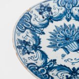 Antique Delft Plate from the early 18th century, crafted at the De Drie Porceleyne Flessies workshop, featuring the WK mark of Willem van der Kool and his widow Cornelia van Schoonhoven.